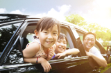 asian family traveling in car