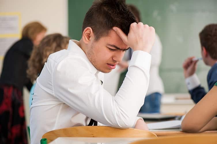 sad student sitting in a classroom BFmoxlAHs image